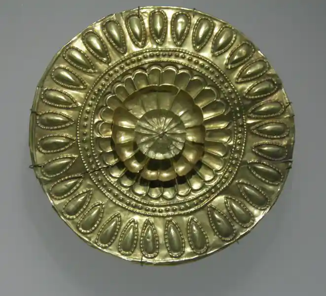 Gold circular plaque with the four layers of sun rays